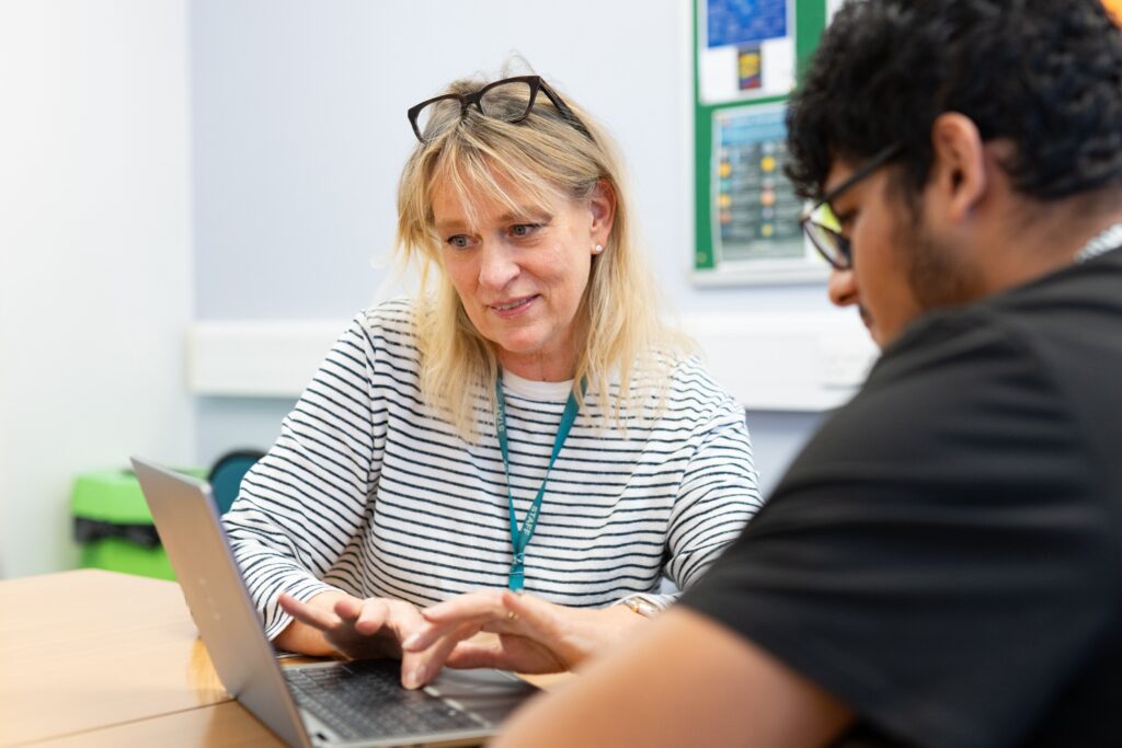 tutor and student looking at computer