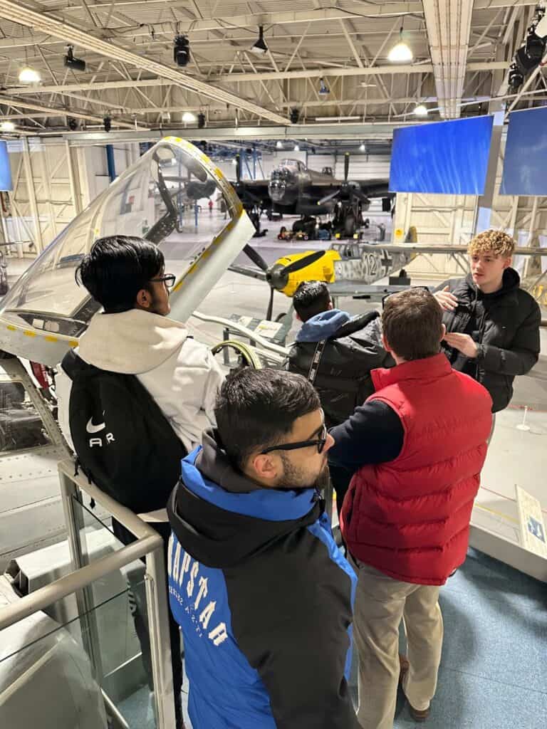 Group of students looking at an old RAF plane